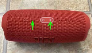 The Charge 5 speaker, top view, showing the -Volume Down- and -Bluetooth- buttons. How to Turn On JBL Charge 5 Bass Mode.