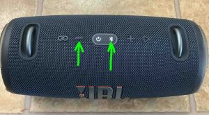 Top view of the JBL Xtreme 3 speaker, showing the -Volume Down- and -Bluetooth- buttons.