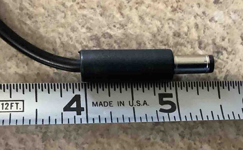 JBL Extreme 2 charger DC output plug against a ruler length wise.