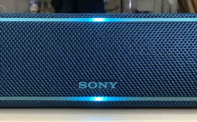 Front view of the Sony SRS XB21 speaker with its lights glowing.