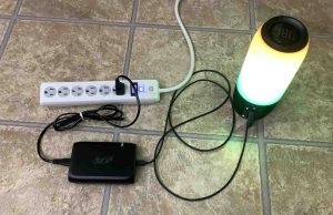 Picture of the speaker connected to AC power and charging.