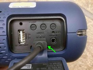 Picture of the XB32 with a charging cable attached.