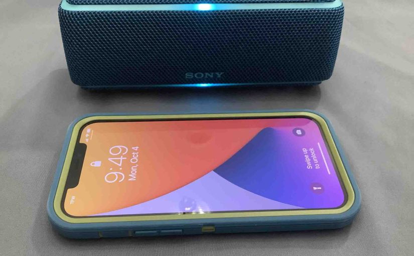 Picture of an iPhone with a Sony SRS XB21 speaker.