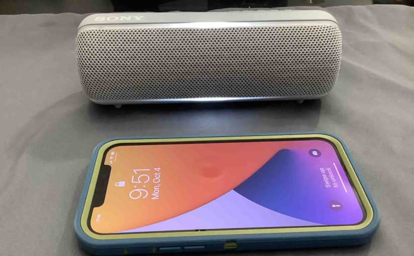 Picture of an iPhone with a Sony SRS XB22 speaker.