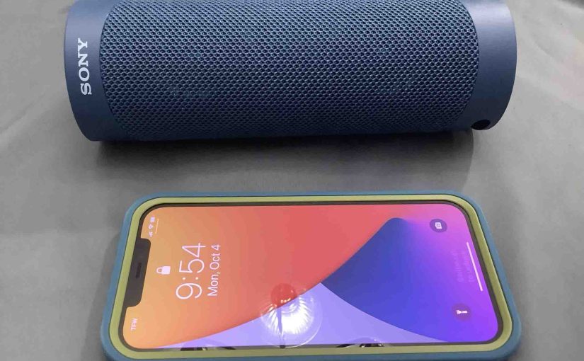 Picture of an iPhone with a Sony SRS XB23 speaker.