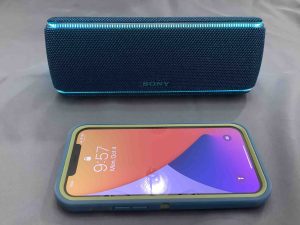 Picture of an iPhone with a Sony SRS XB31 speaker.