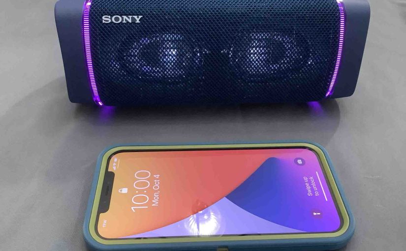 Picture of an iPhone with a Sony SRS XB33 speaker.
