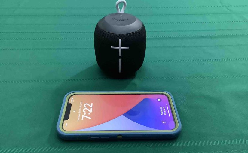 Picture of an iPhone in front of the Wonderboom 1 speaker.