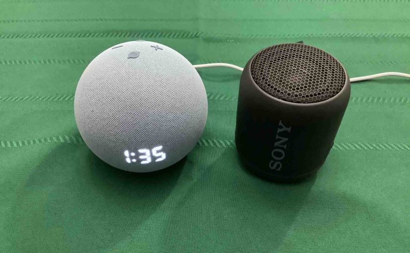 Picture of an Alexa Dot 4 speaker clock alongside a Sony SRS XB12 speaker.