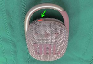 Picture of the red light glowing on the JBL Clip 4 speaker.