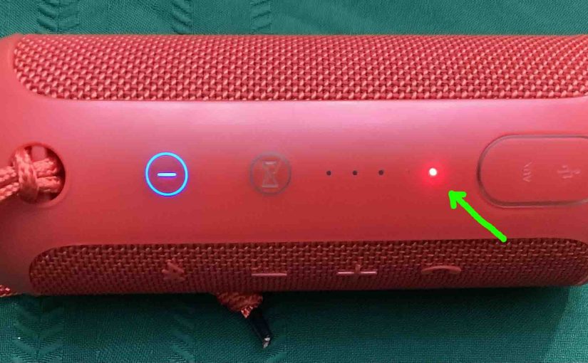 The red light glowing on the JBL Flip 3 speaker.