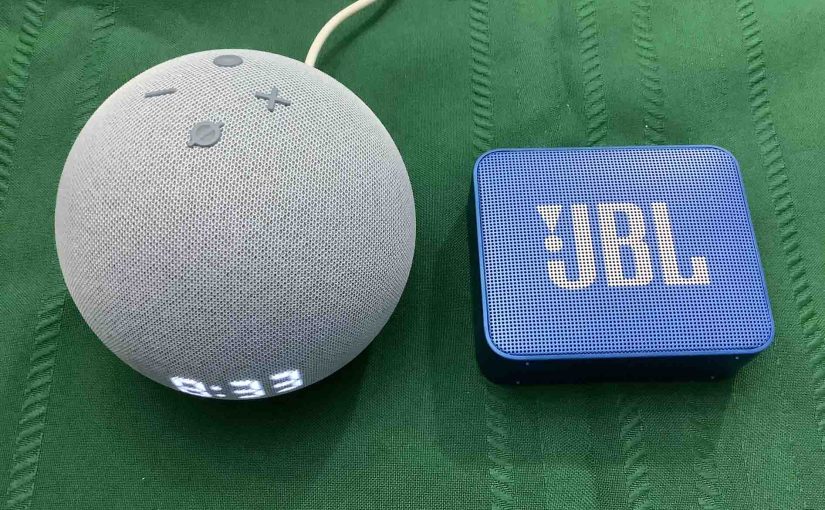 Picture of an Echo Dot 4 clock alongside a JBL Go 2 speaker.