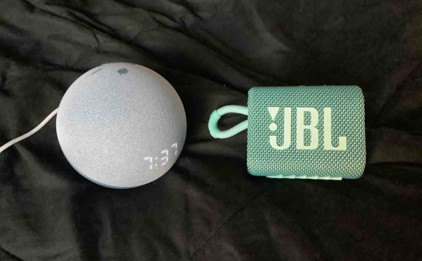 Picture of the Echo Dot 4 clock speaker alongside a JBL Go 3 speaker.