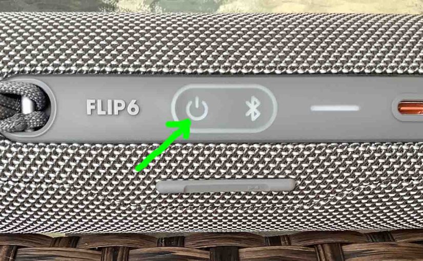 Picture of the dark -Power- button on the JBL Flip 6 speaker.