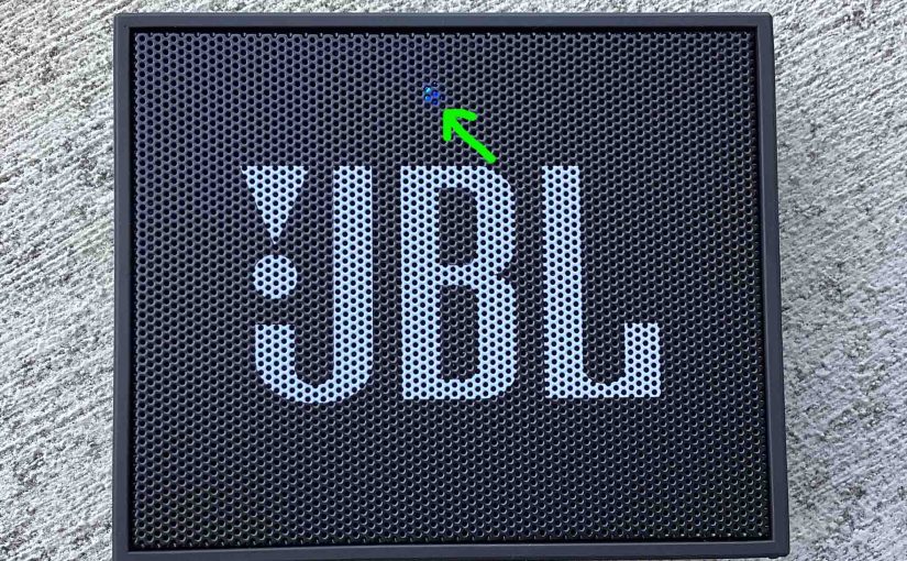 Picture of the blue glowing status light on the front of the JBL Go speaker.