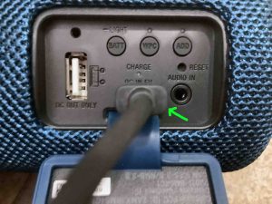 Picture of a USB charging cable inserted into the Sony XB31.