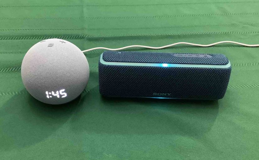 Picture of an Echo Dot 4 clock speaker alongside a Sony SRS XB21 BT speaker.