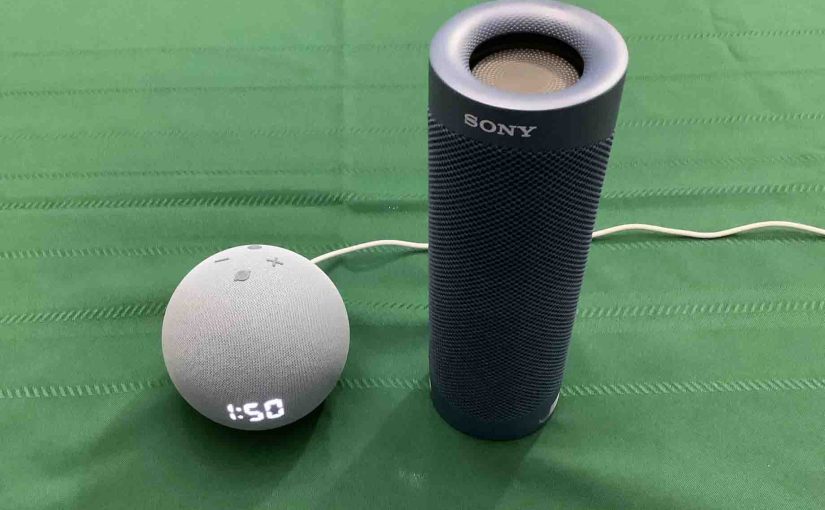 Picture of an Echo Dot 4 clock speaker alongside a Sony SRS XB23 Bluetooth speaker.