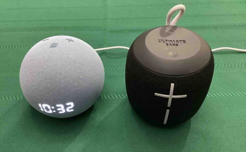 Picture of an Echo Dot 4 speaker clock alongside a UE Wonderboom BT speaker.