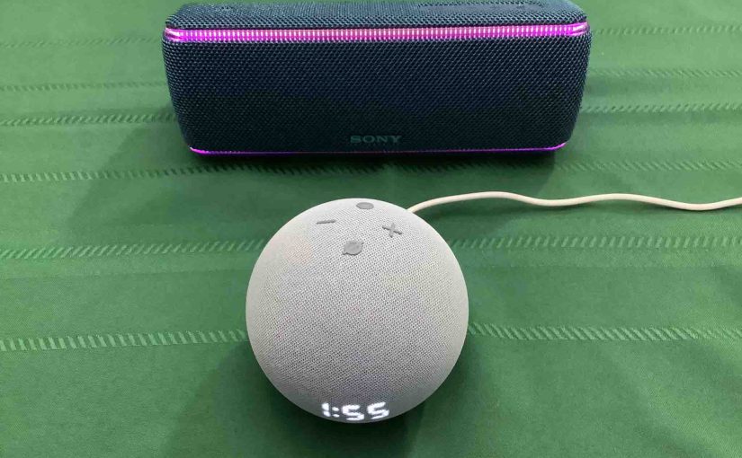 Picture of an Echo Dot 4 clock speaker in Front of a Sony SRS XB31 wireless speaker