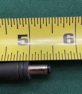 Picture of the JBL Boombox 2 charger adapter DC output plug against a ruler length wise.