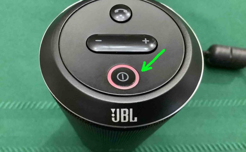 Picture of the red glowing battery indicator on the JBL Flip speaker.