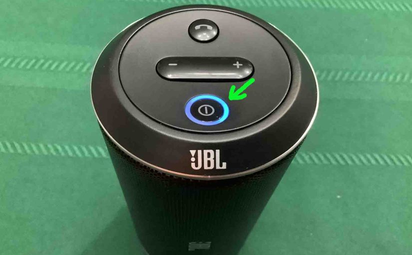 Picture of The glowing Power / Pairing button on the JBL Flip speaker.