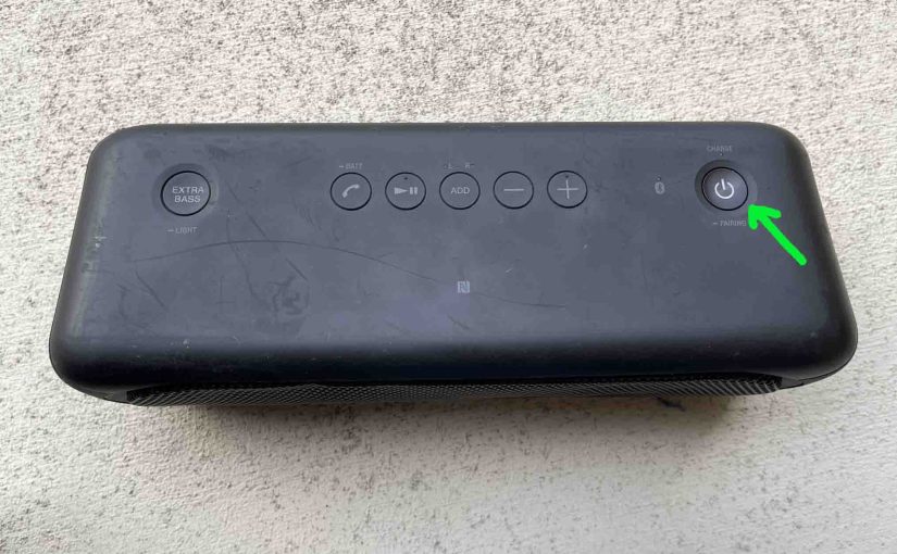 Picture of the dark Power button on the Sony SRS XB40 speaker.