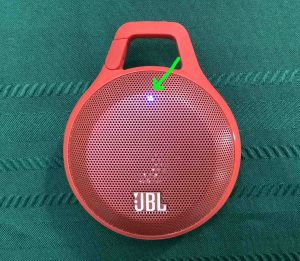 Picture of the blue status light on the front of the JBL Clip speaker.