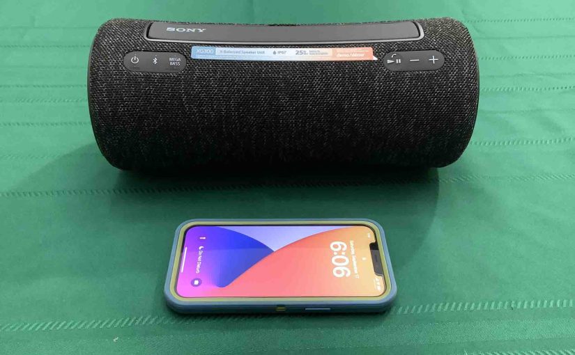 An iPhone in front of the Sony SRS XG300 speaker.