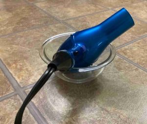 Picture of a Conair Infinity Pro hairdryer, aimed upward from inside a Pyrex bowl.