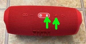 Picture of the top of the JBL Charge 5 speaker, with the -Bluetooth Pairing- and -Volume UP- buttons highlighted.