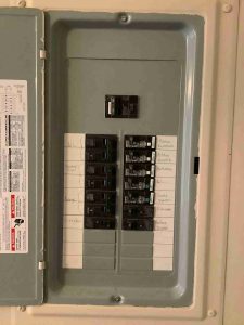 Picture of a Siemens indoor load center circuit breaker box, front view, with door open.